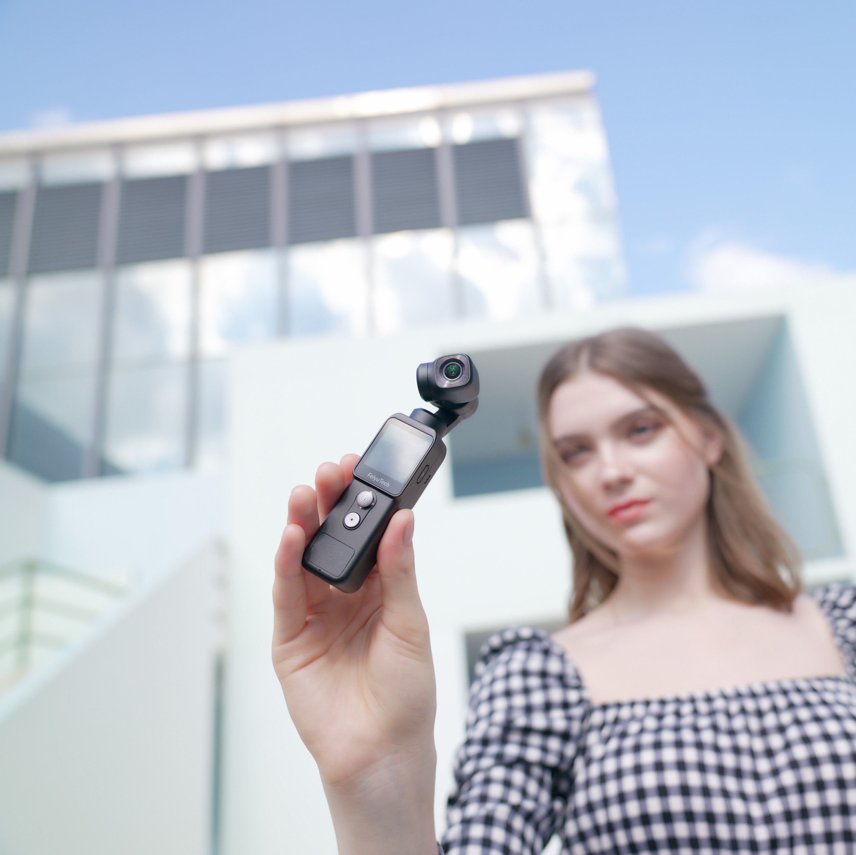 A girl uses Feiyu Pocket 2 to take a photo